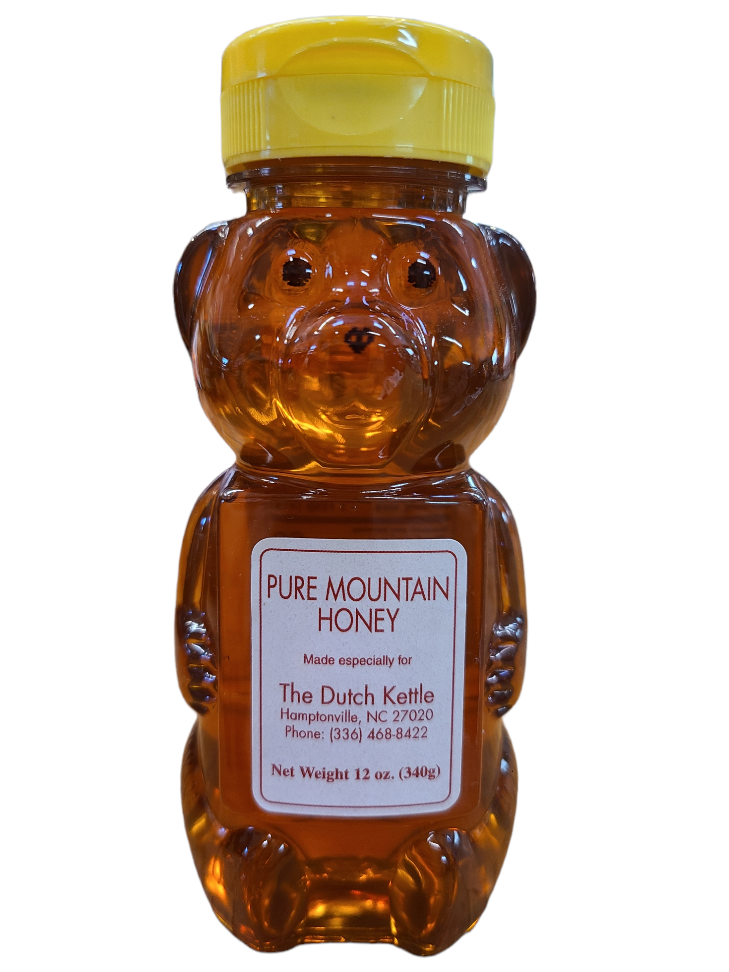 Small plastic bottle in the shape of a bear with a snap cap lid containing honey