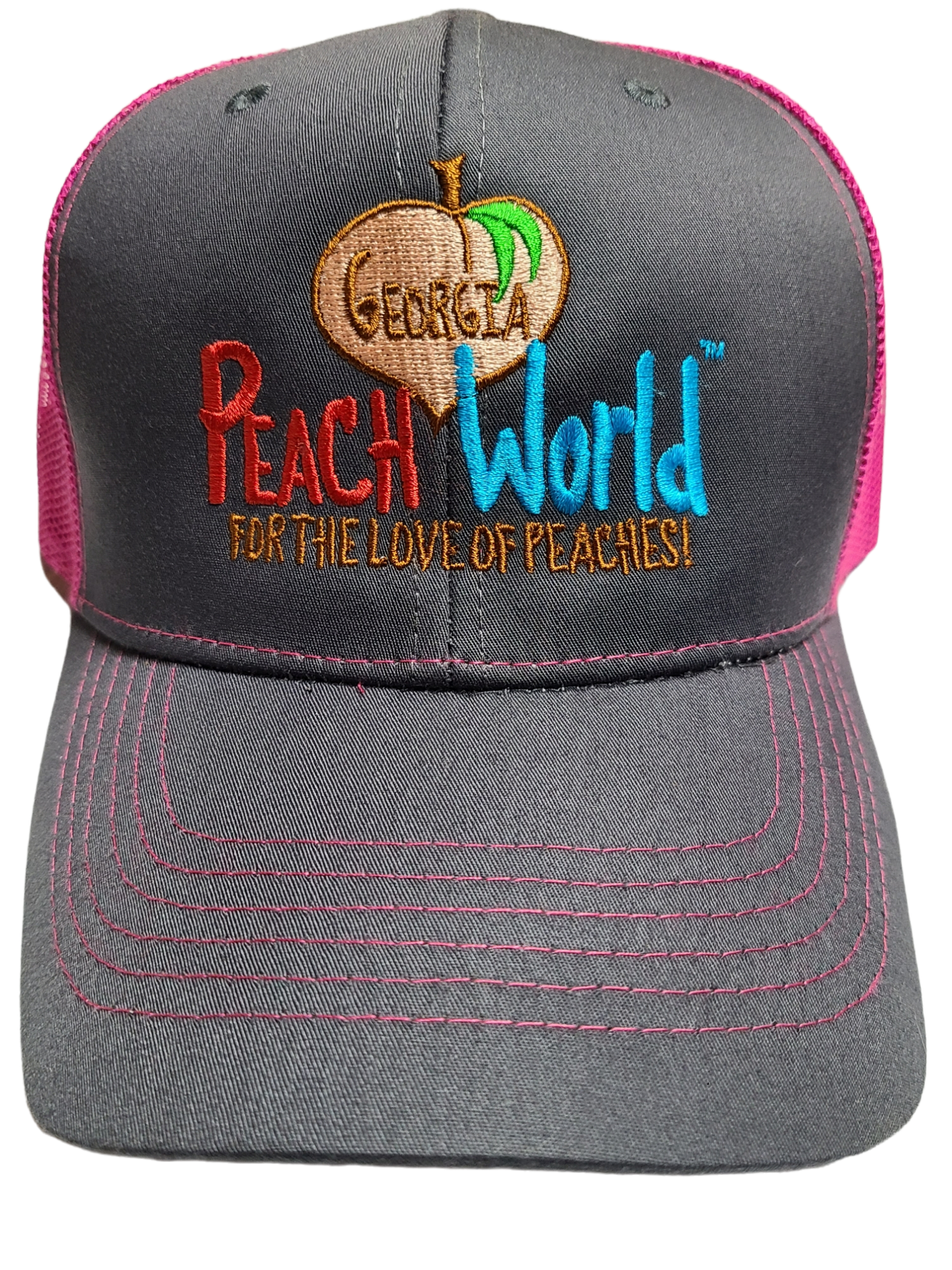 Charcoal colored Richardson brand trucker style hat with a pink mesh back printed with Georgia Peach World branding logo