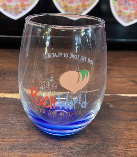 Blue bottomed wine glass without a stem printed with Georgia Peach World branding logo. Text that reads "For the love of peaches is printed on the backside.